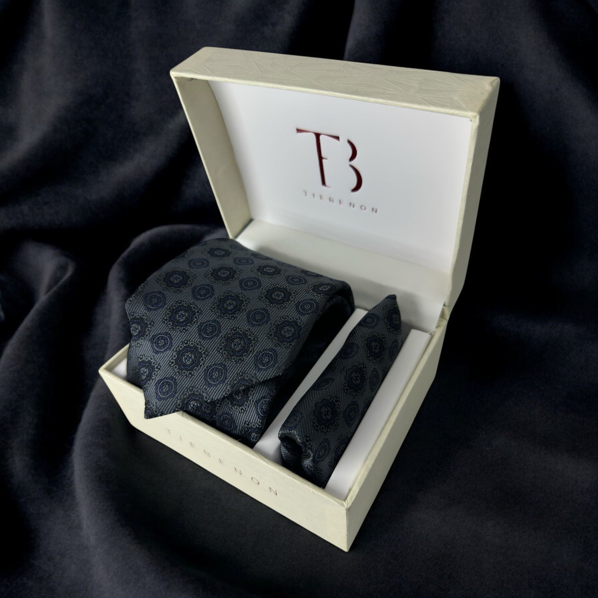 A Tie Benon gray tie with pocket square set, presented in a white box with a Tie Benon branding on the top.