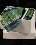 Green plaid tie and pocket square set in a white box on a black background Tie Benon