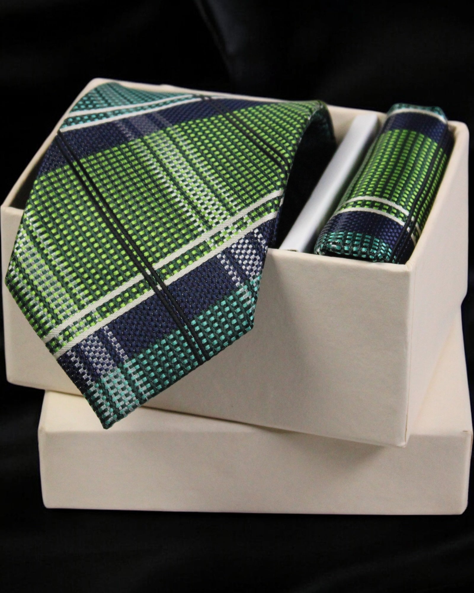 Green plaid tie and pocket square set in a white box on a black background Tie Benon
