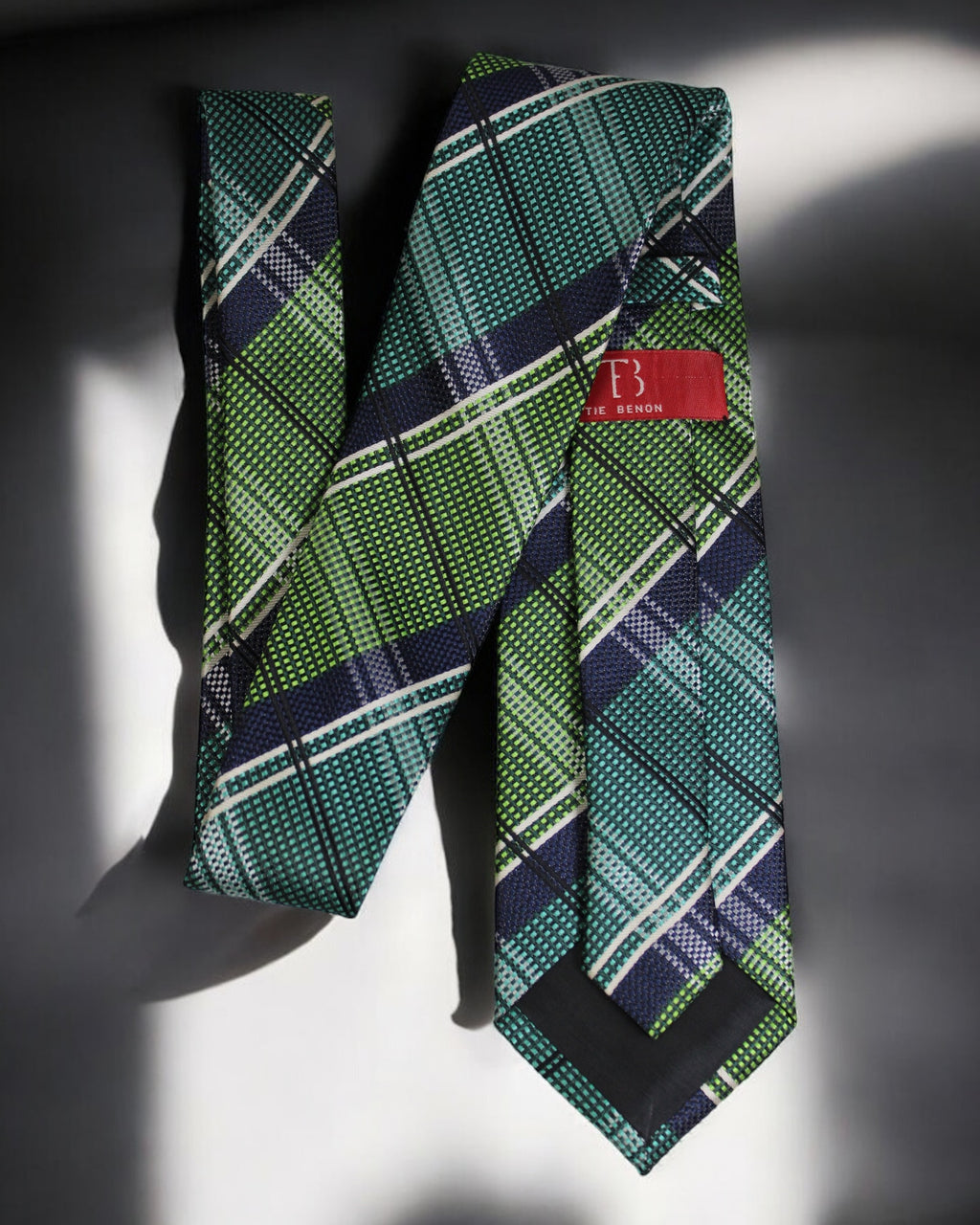 Green plaid tie with a red label on a dark background Tie Benon
