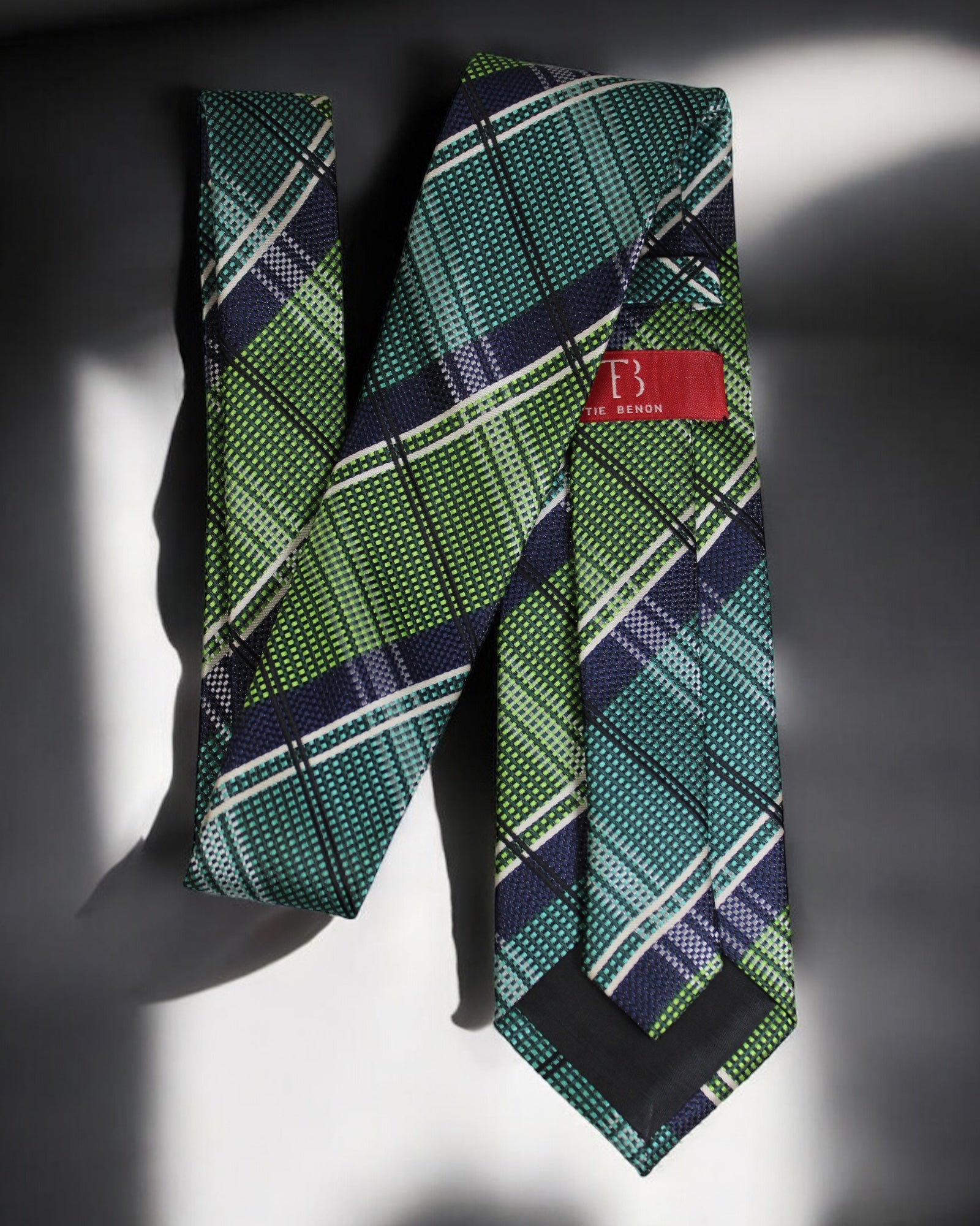Green plaid tie with a red label on a dark background Tie Benon