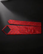 Red patterned tie on a black background