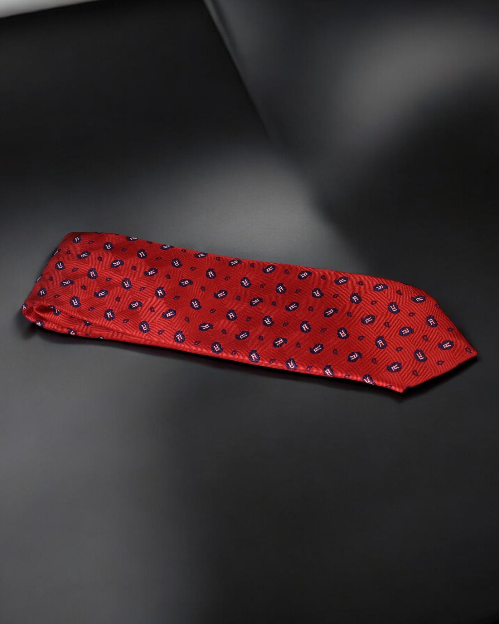 Red patterned tie on a dark gray background