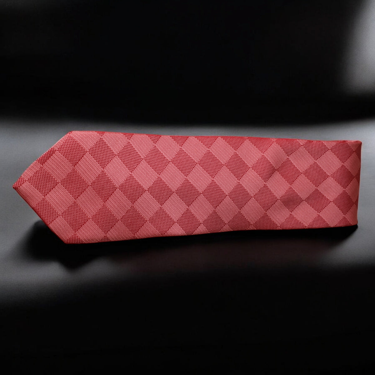 Red patterned tie on a black background
