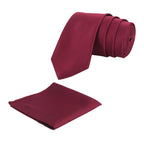 A solid burgundy necktie with a matching pocket square, displayed in a rolled-up configuration.