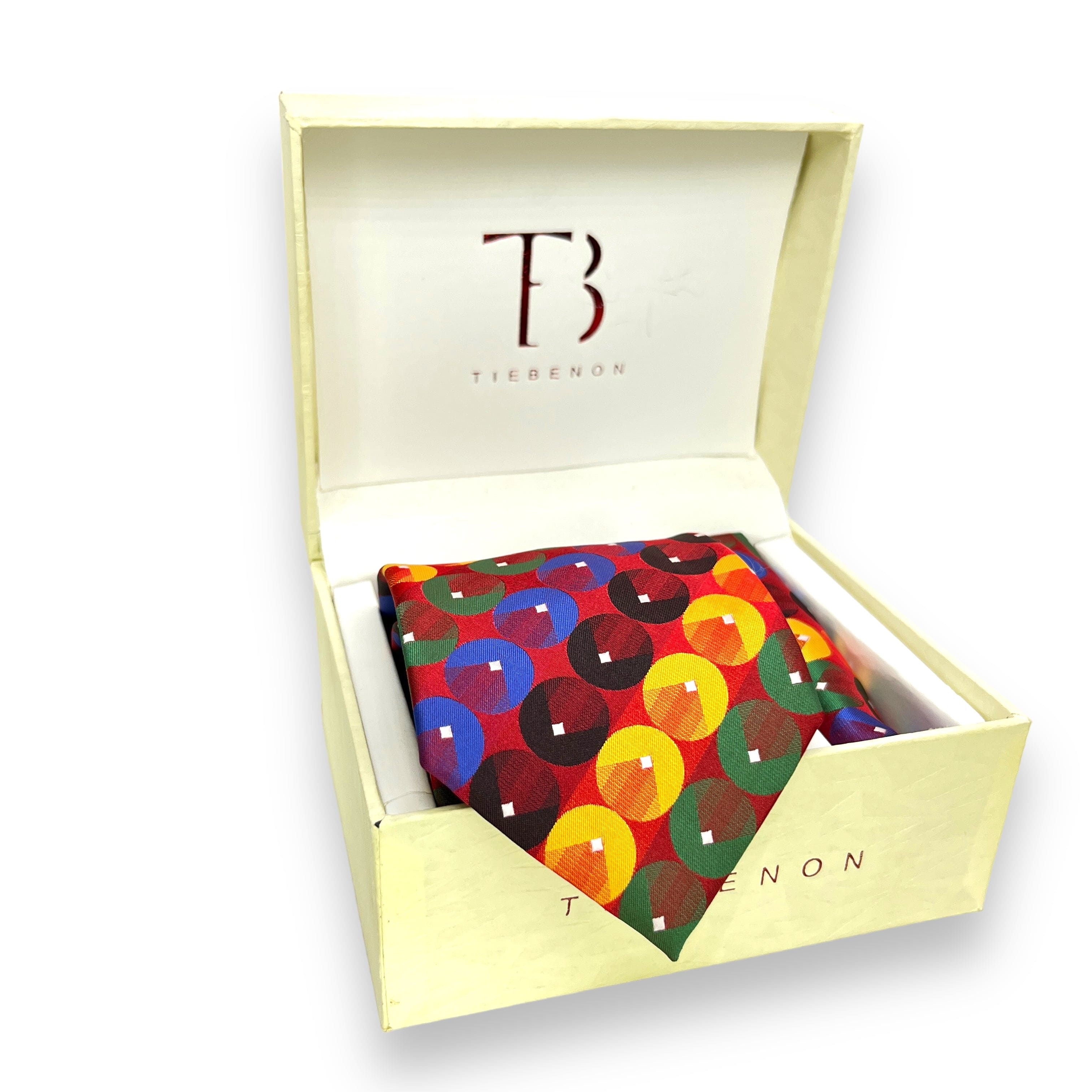 A multicolor geometric patterned tie inside a white box with a brand logo on the top.