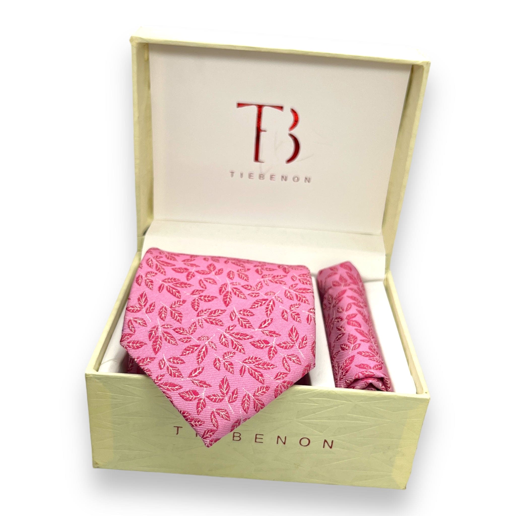 A pink microsilk tie with a leaf pattern and a matching pocket square, both displayed in an open white box with the brand name 'Tie Benon' on it.